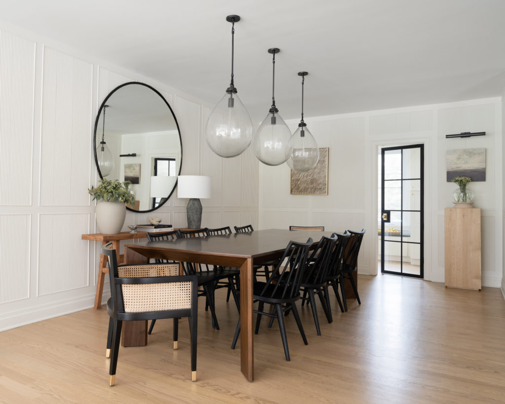 Interior designer photoshoot featuring a modern and classic dining room with reeded paneling and studio mcgee pedestal.