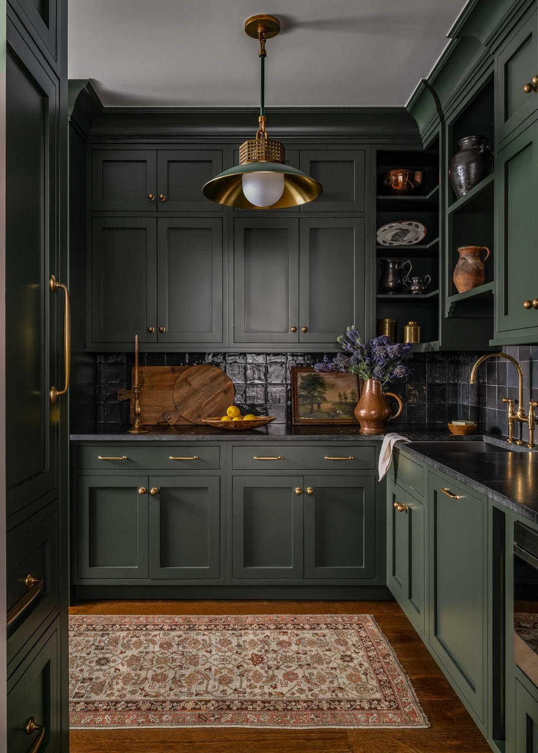 Editorial interior photography by Tori Sikkema featuring Town & Country Design Studio’s fall-inspired project: a moody brass bar with Urban Electric lighting, a sunlit kitchen with oak cabinetry and veined marble, and a deep green pantry with cinematic shadows—capturing light, mood, and design legacy.