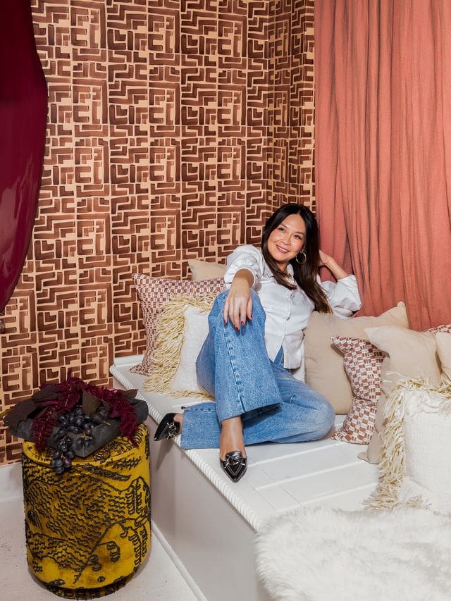 Editorial portrait of interior designer Christina Kim in a color-rich, sculptural interior