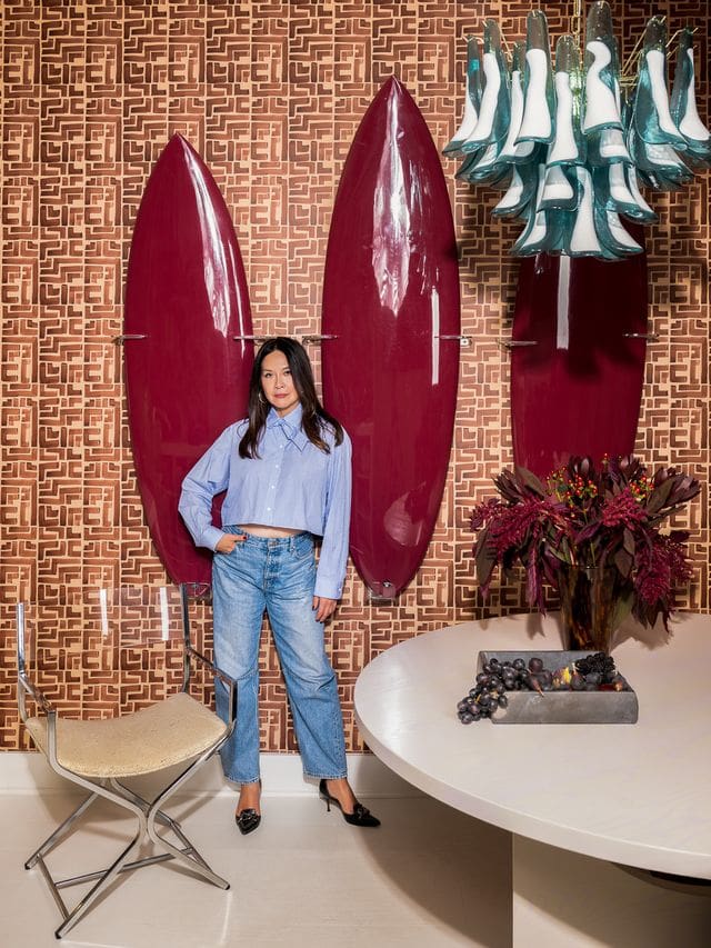 Editorial portrait of interior designer Christina Kim in a color-rich, sculptural interior