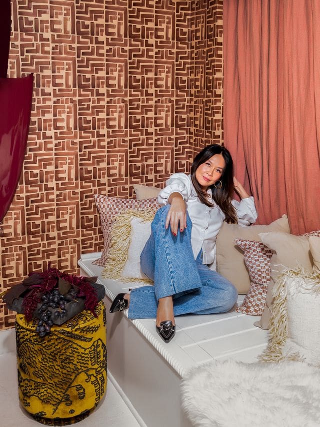 Editorial portrait of interior designer Christina Kim in a color-rich, sculptural interior